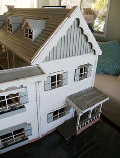 a doll house is sitting on top of a table