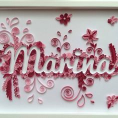 the word marina is made out of pink paper flowers and swirls on a white background