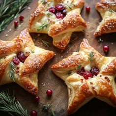 christmas pastries with cranberries and rosemary sprigs on a cutting board