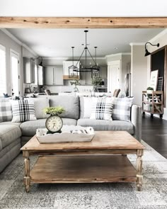 a living room filled with furniture and a wooden coffee table in front of a couch