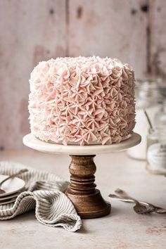 a close up of a cake on a plate near other food and utensils