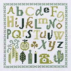 the cross stitch alphabet is shown in green and yellow