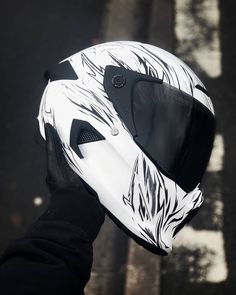 a person wearing a white and black motorcycle helmet