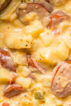 a close up view of some food with cheese and sausages on the top,