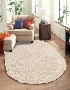 a living room with a chair, ottoman and rug