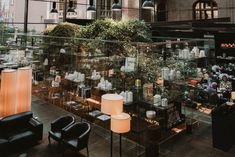 a room filled with lots of different types of furniture and lighting on top of wooden flooring