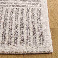 a close up of a rug on a wooden floor with wood floors and white carpet