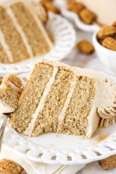 a slice of cake on a white plate with a fork in front of the cake