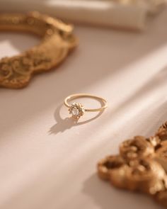 a gold ring sitting on top of a white table