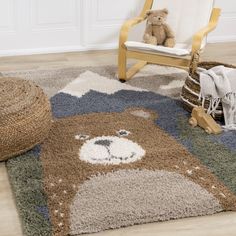 a teddy bear sitting on top of a rug next to a rocking chair