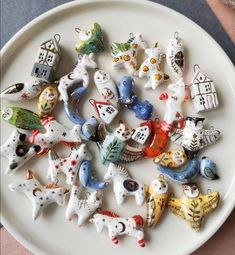 a white plate topped with lots of small figurines