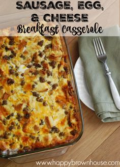 sausage, egg and cheese breakfast casserole on a wooden table with a fork