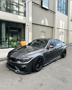 a black car parked in front of a building