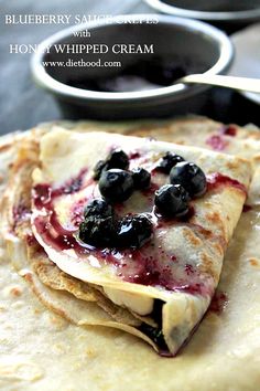 blueberry crepes are stacked on top of each other and ready to be eaten