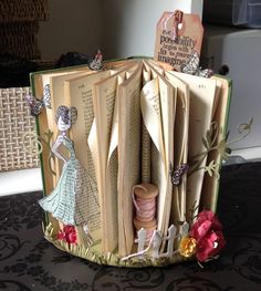 an open book decorated with paper and flowers