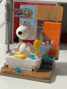 a lego model of a snoopy sitting in a bathtub