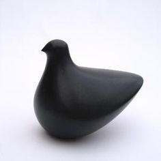 a black bird statue sitting on top of a white table