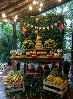 an outdoor party with bananas on the table and decorations in wooden crates around it,