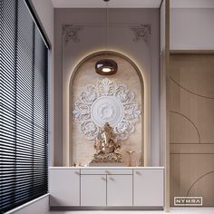 a white and gold room with a buddha statue on the wall next to a cabinet