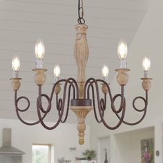 a chandelier hanging from the ceiling in a kitchen