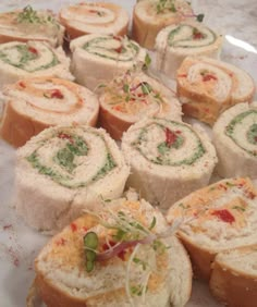 several rolls are arranged on a plate with sprinkles and garnishes