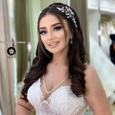 a woman in a wedding dress is posing for the camera