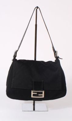 OR 4 interest-free installments of $187.50 USD by Vintage Fendi shoulder bag in black cotton canvas. Top flap with black leather closure and silver logo hardware. Magnetic button closure. One large interior compartment with one inner zip pocket Dimensions (inches): 11 W x 7 H x 4 W Condition: Excellent Black Vintage Bag, Black Fendi Bag, Fendi Baguette Vintage, Vintage Fendi Baguette, Vintage Fendi Bag, Fendi Crossbody Bag, Fendi Baguette Bag, Japan Shopping, Fendi Shoulder Bag