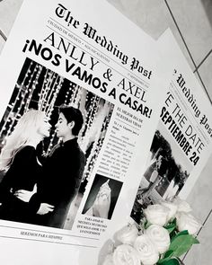 a couple is kissing on their wedding day with newspaper and flowers in front of them