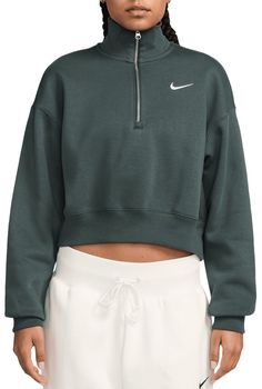 Grounded in style, comfort and versatility, meet Nike's take on luxury loungewear. This 1/2-zip sweatshirt is cropped for a trend-right look, while taller ribbing at the hem, cuffs and collar adds structure to the overall fit. Made from midweight fleece, it's sure to be one of your new cold-weather favorites. Fit & Design: Oversized fit: exaggerated and spacious midweight brushed fleece feels extra soft on the inside and smooth on the outside, helping you stay cozy while keeping its structured shape Dropped shoulder seams and roomy sleeves provide a casual, relaxed look Elongated ribbing at the hem, cuffs and collar provides extra comfort and structure 1/2-length zipper Embroidered Swoosh logo Nike Sportswear Phoenix Fleece, Womens Athletic Outfits, Luxury Loungewear, Women's Sportswear, Loungewear Luxury, Half Zip Sweatshirt, Swoosh Logo, Athletic Apparel, Athletic Outfits