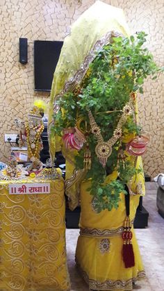 an elaborately decorated statue next to a potted plant