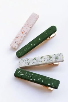 three green and white hair clips sitting next to each other