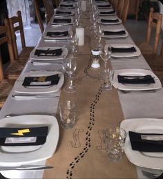 a long table set with place settings and place settings for the dinner guests to enjoy