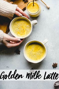 two people holding mugs of golden milk latte