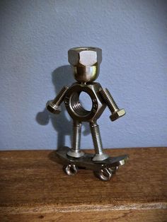 a small metal toy sitting on top of a wooden table