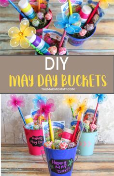 two buckets filled with candy and flowers on top of a wooden table next to the words, diy may day buckets