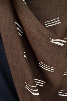 the fabric is brown with white lines on it