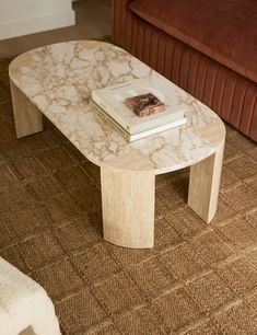 a marble coffee table with two books on top