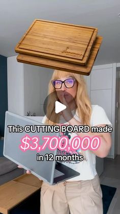 a woman is balancing a laptop on her head with a wooden tray over her head