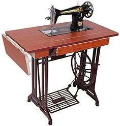 an old sewing machine sitting on top of a wooden table