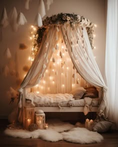 a canopy bed with lights hanging from it's sides and fur rugs on the floor