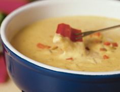 a blue bowl filled with soup sitting on top of a table