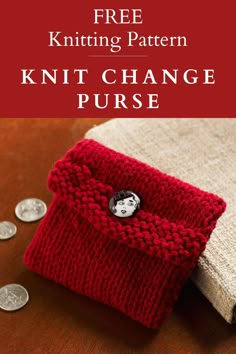 a red knitted purse sitting on top of a wooden table next to some coins