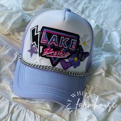 "This \"Lake Babe\" patch hat is adorable and perfect for any babe who loves a great summer day out on the lake!  This makes the PERFECT gift for the summer, the perfect lake day accessory! All patches are attached via commercial heat press! Check out my other listings for other options, if you don't see what you are looking for just message me! I love doing custom orders as well to make your dreams a reality! This listing is for the hat only! The hat is a one-size-fits-all snapback style trucker hat that can be adjusted! Please remember that each of my hats is made-to-order, so the size of patches & placement may slightly differ than the hat pictured! It is available as large patch only, whole patch cluster, or whole patch cluster with hat chain! Please see the matching listing on my shop Cute Festival Trucker Hat, 90s Style Adjustable Hats For Summer, 90s Style Adjustable Summer Hats, 90s Summer Cap, 90s Style Summer Cap, Trendy Cap For Music Festival, Trendy Purple Baseball Cap, 90s Summer Streetwear Hats, 90s Style Summer Streetwear Hats