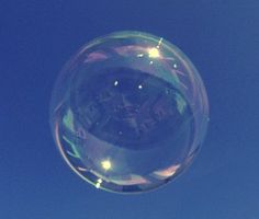 a clear bubble floating in the air on a sunny day