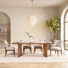 a dining room table with chairs and a chandelier