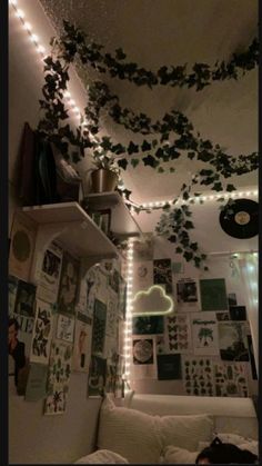 the ceiling is decorated with ivy vines and string lights in this dorm room at night