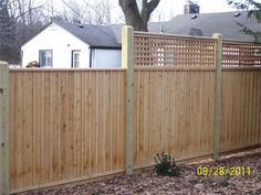 a wooden fence in front of a house