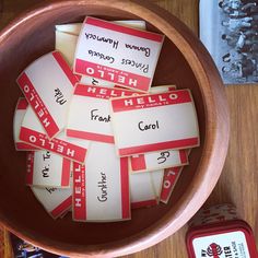 several red and white labels in a wooden bowl