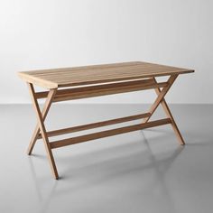 a wooden table sitting on top of a white floor