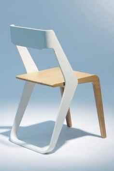 a white and wooden chair on a blue background